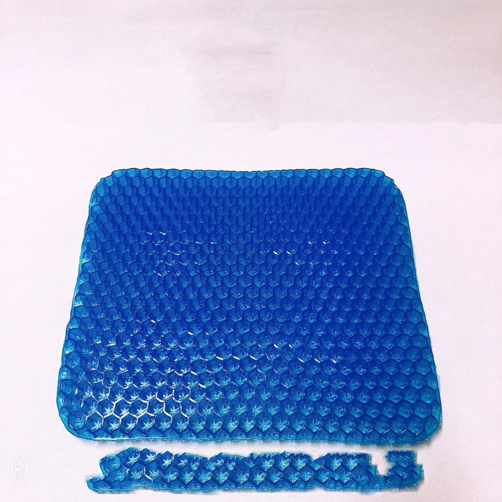 Gel seat cushion with honeycomb pattern showing double thick construction and removable PVC cover