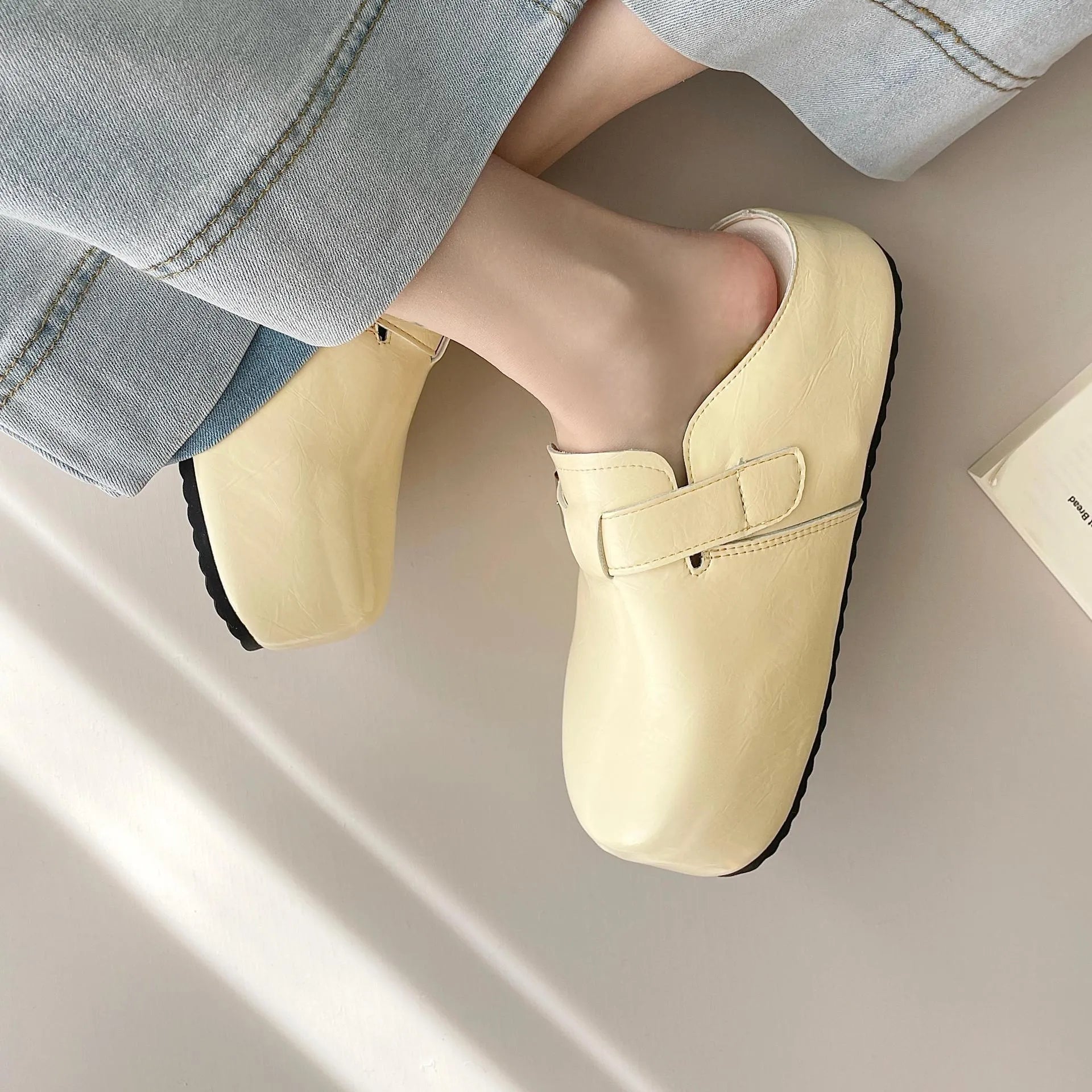 Flat buckle casual sneakers in creamy-white with round toe and PU leather upper.