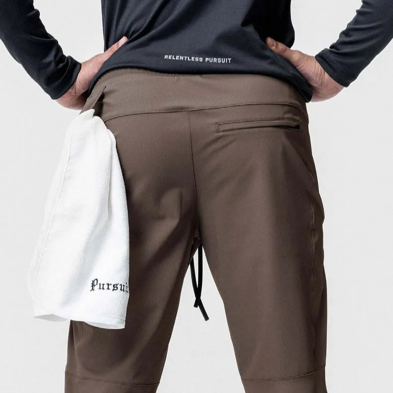 Men's grey loose-fit fitness trousers with ankle ties and quick-drying polyester fabric