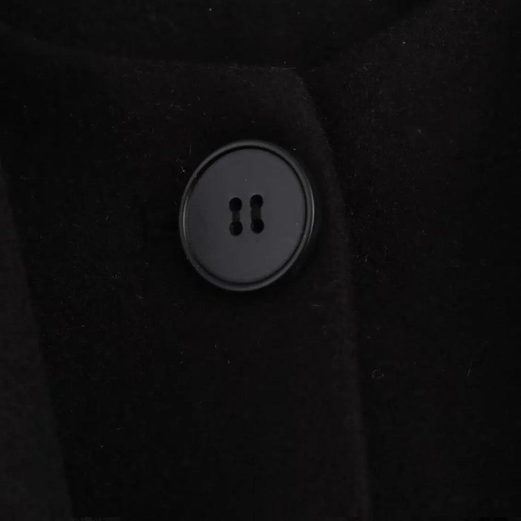 Women's long grey polyester overcoat with artificial fur collar and pockets, shown in a street fashion style.