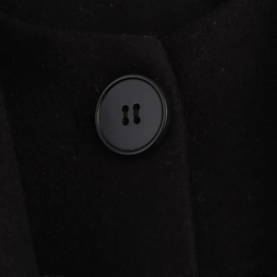 Women's long grey polyester overcoat with artificial fur collar and pockets, shown in a street fashion style.