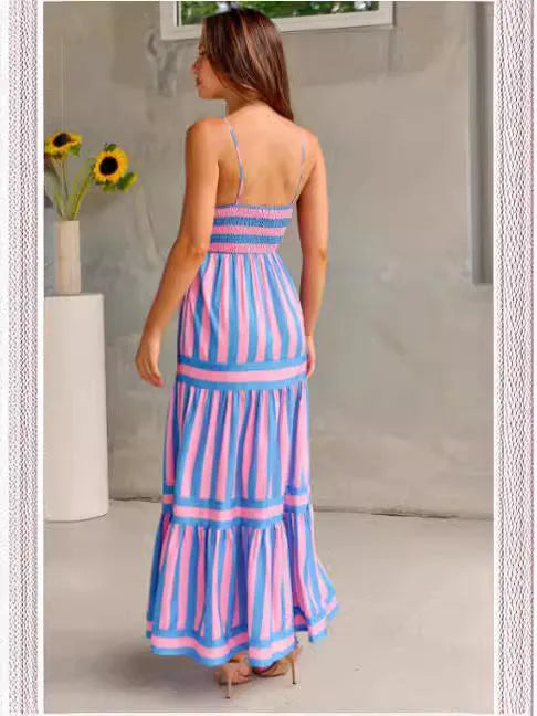 Women's striped backless summer dress with suspender straps and side pockets in a blue colour.