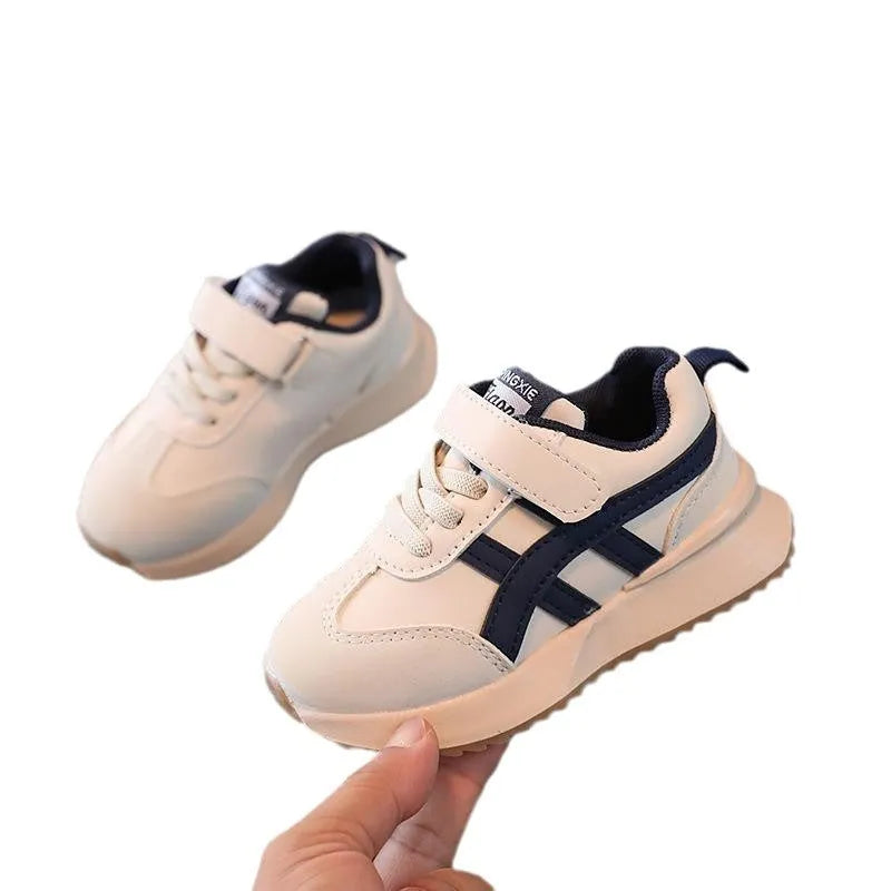 Children's white casual sneaker with Velcro fastening and rubber sole shown on size label.