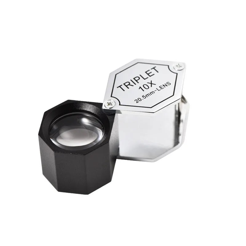 Handheld metal magnifying glass with optical glass lens for jewellery and stamp inspection.