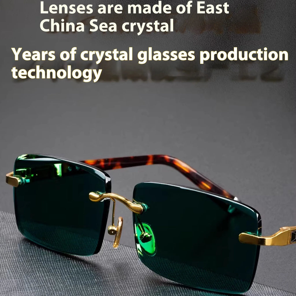 A pair of dark green frameless crystal sunglasses presented with a matching glasses case and a lens cloth.