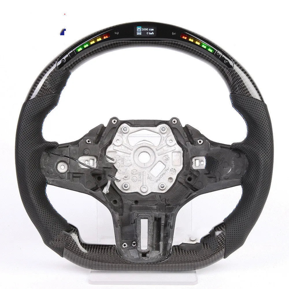 Black carbon fibre BMW sports steering wheel with integrated LED multifunctional display.