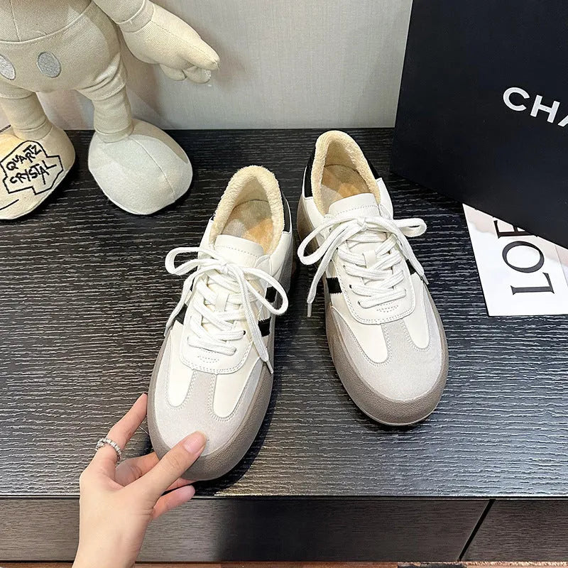 Women's beige vintage distressed leather sneakers with round toe and lace-up front on a rubber sole.