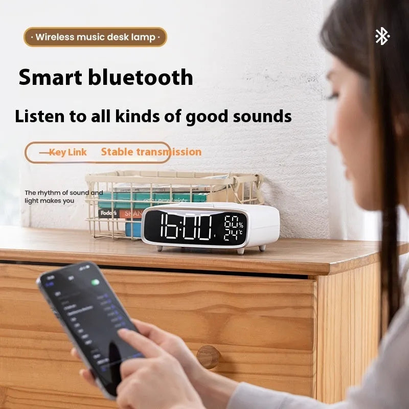 White wireless charger with Bluetooth speaker and night light on bedside table