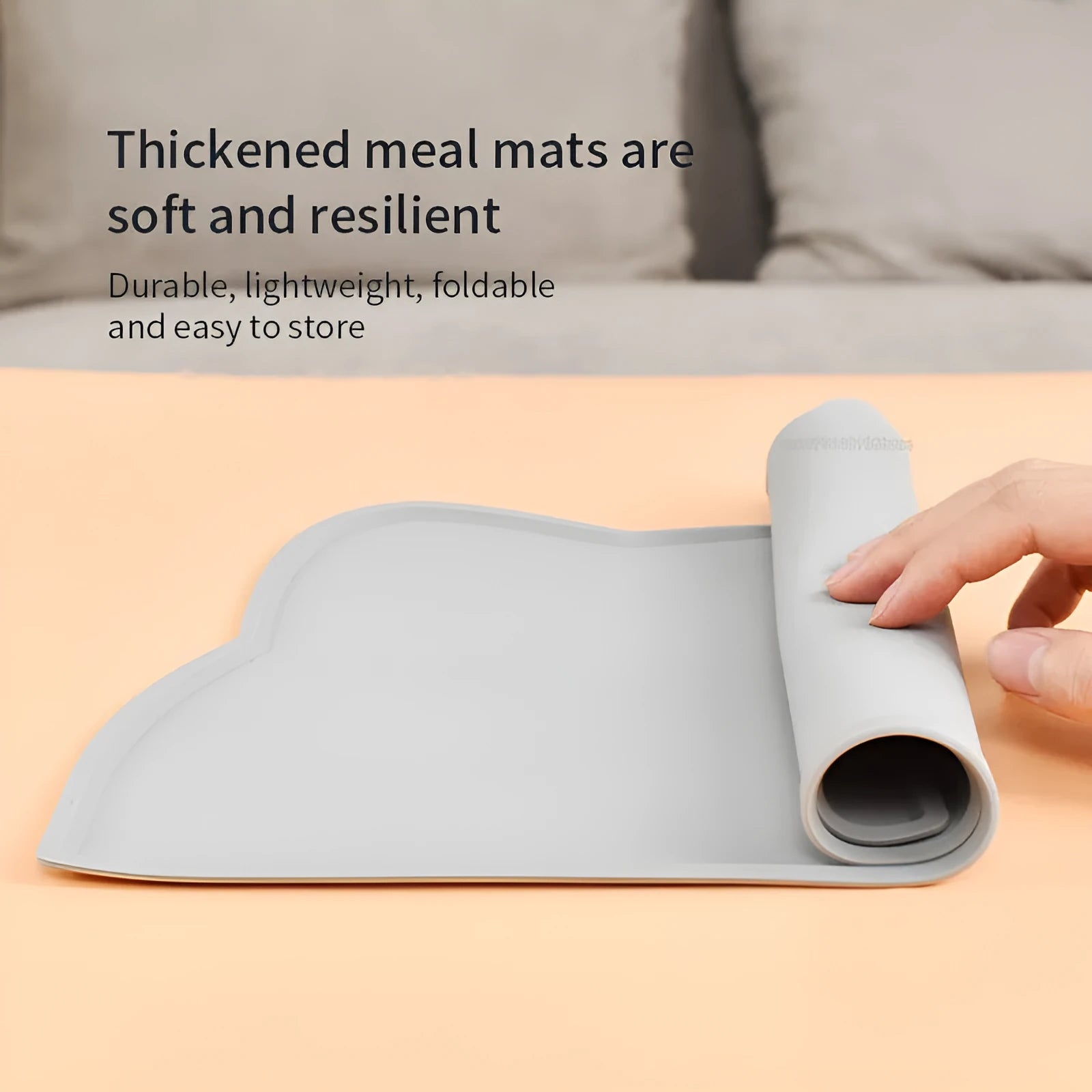 Blue silicone pet feeding mat under food and water bowls measuring 44 by 24 centimetres