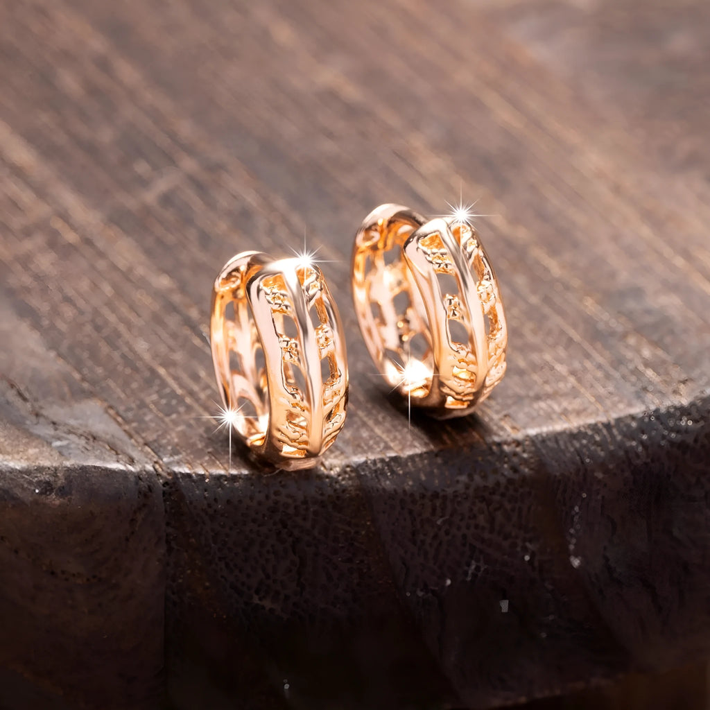 Rose gold finished leaf-shaped hollowed-out earrings with heart detail on copper base