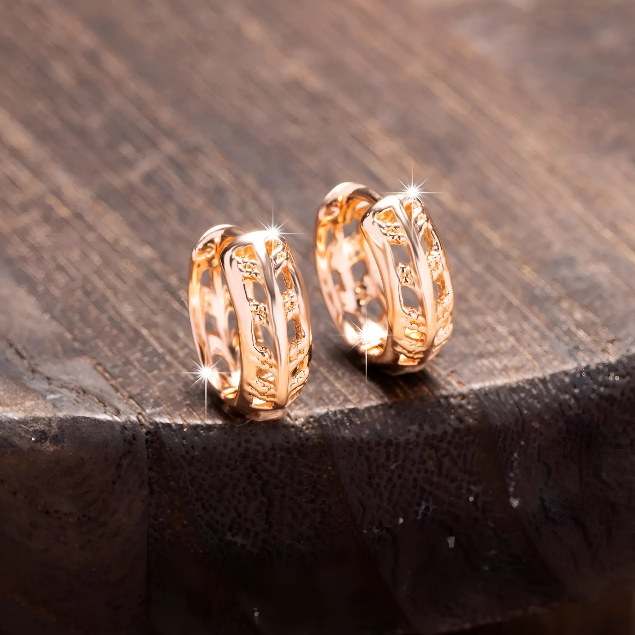 Rose gold finished leaf-shaped hollowed-out earrings with heart detail on copper base