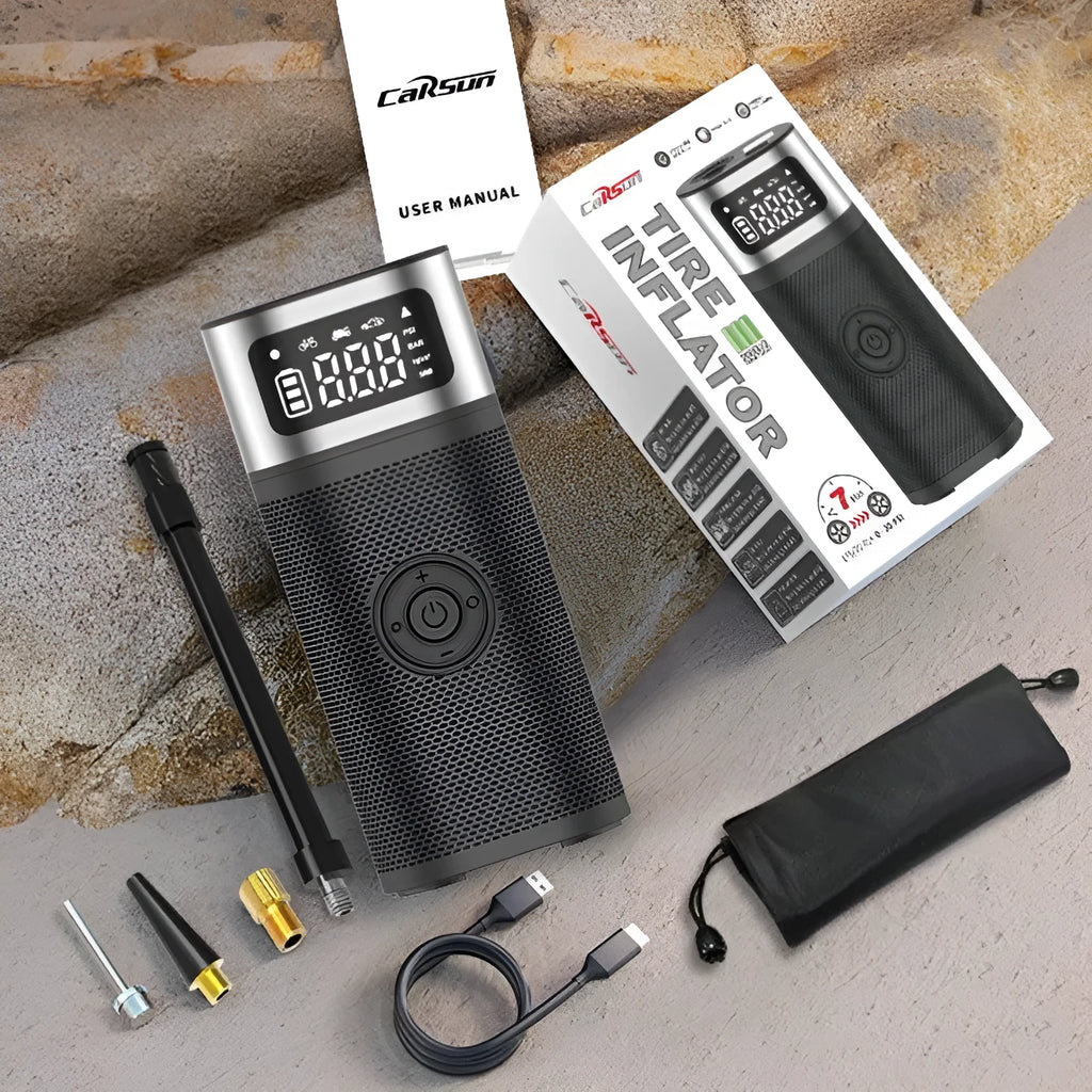 Black portable wireless smart vehicle air pump with a display, inflation tube, and multiple nozzles on a dark background.