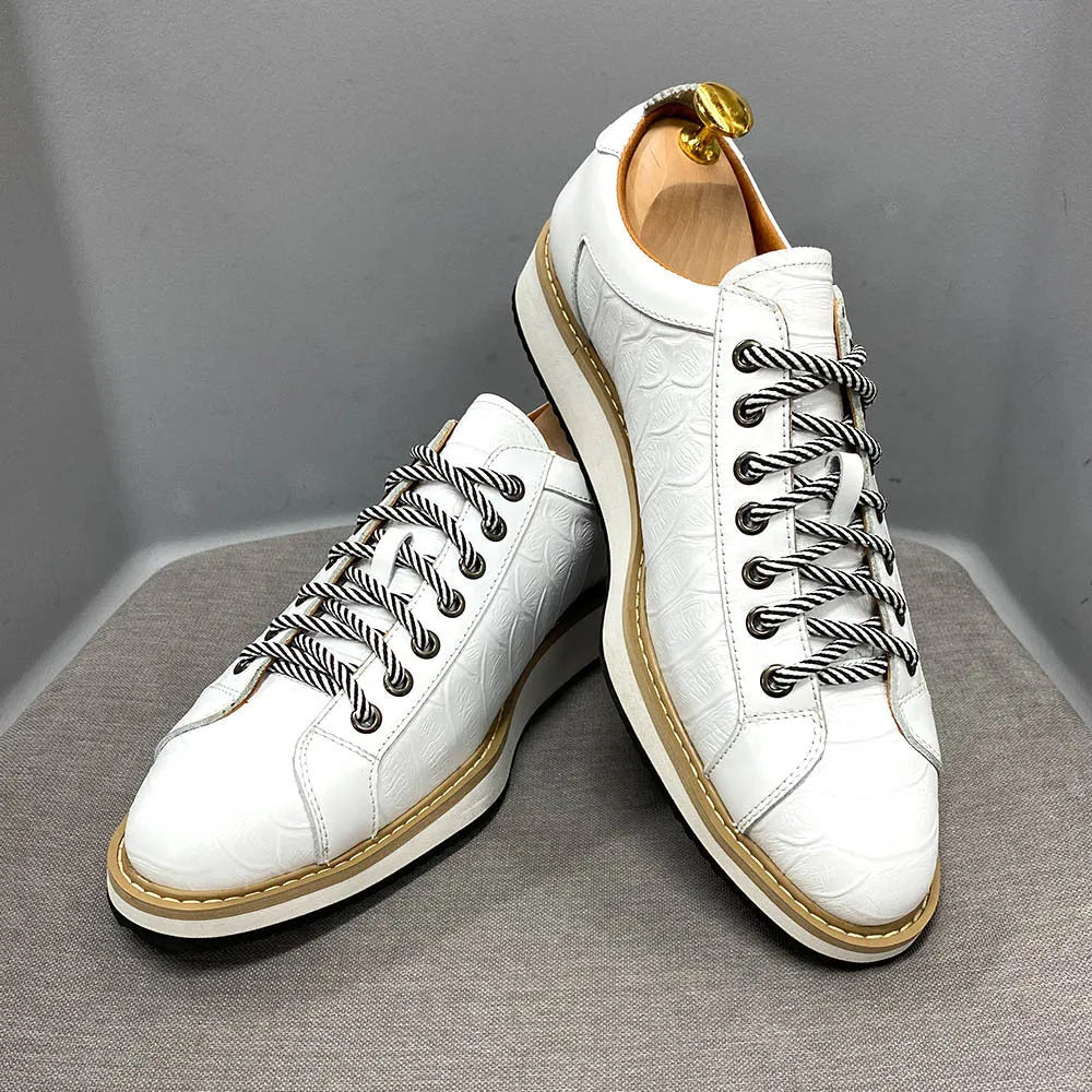 Men's low-top handmade lace-up shoes with an embossed pattern on the upper, shown in a choice of colours.