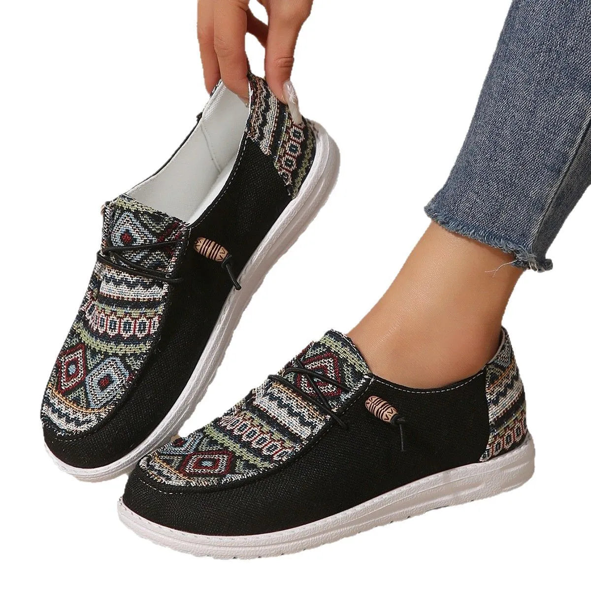 Women's low-top flat slip-on shoes in black with a round toe and rubber sole.