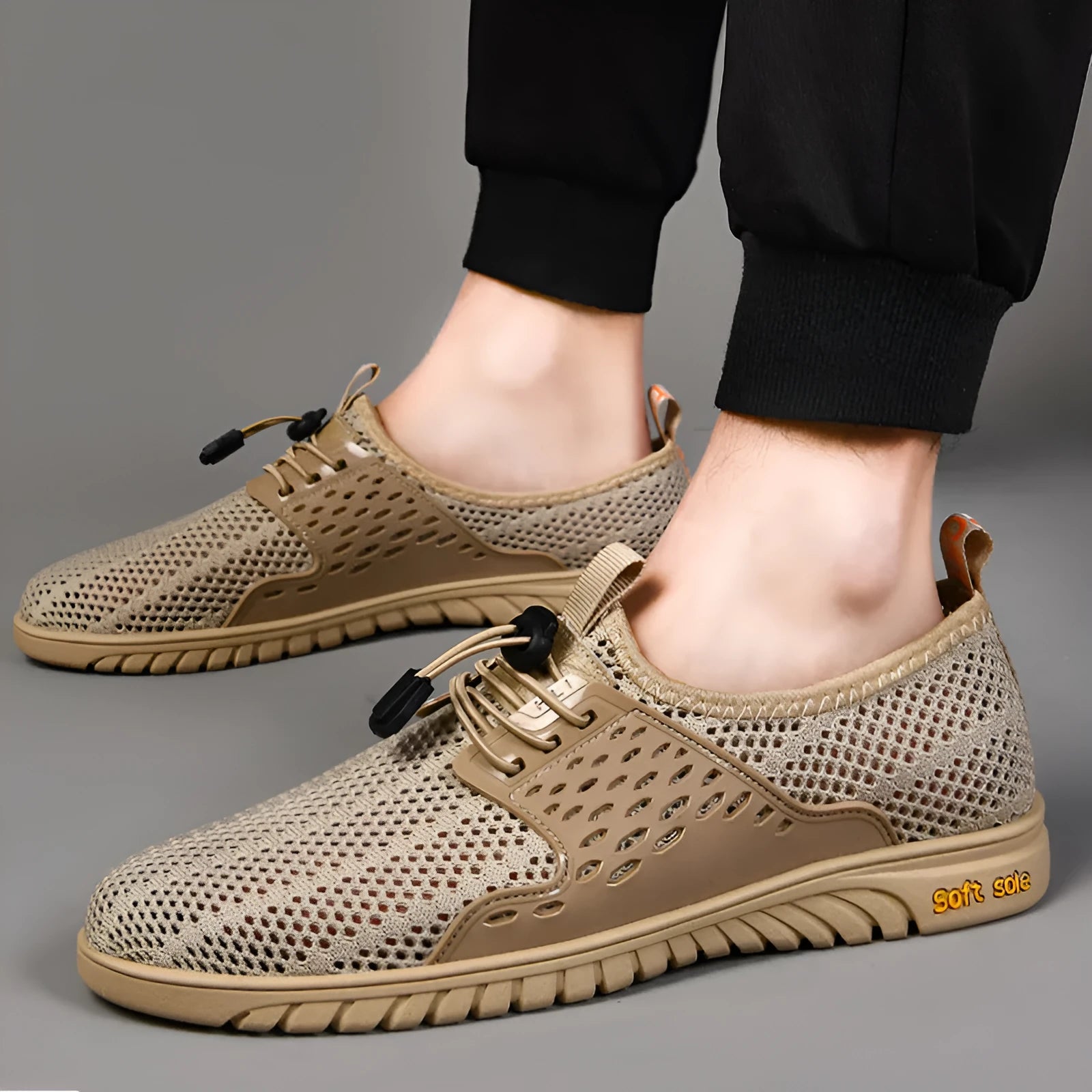 Men's black mesh casual shoes with elastic band and rubber sole on a white background