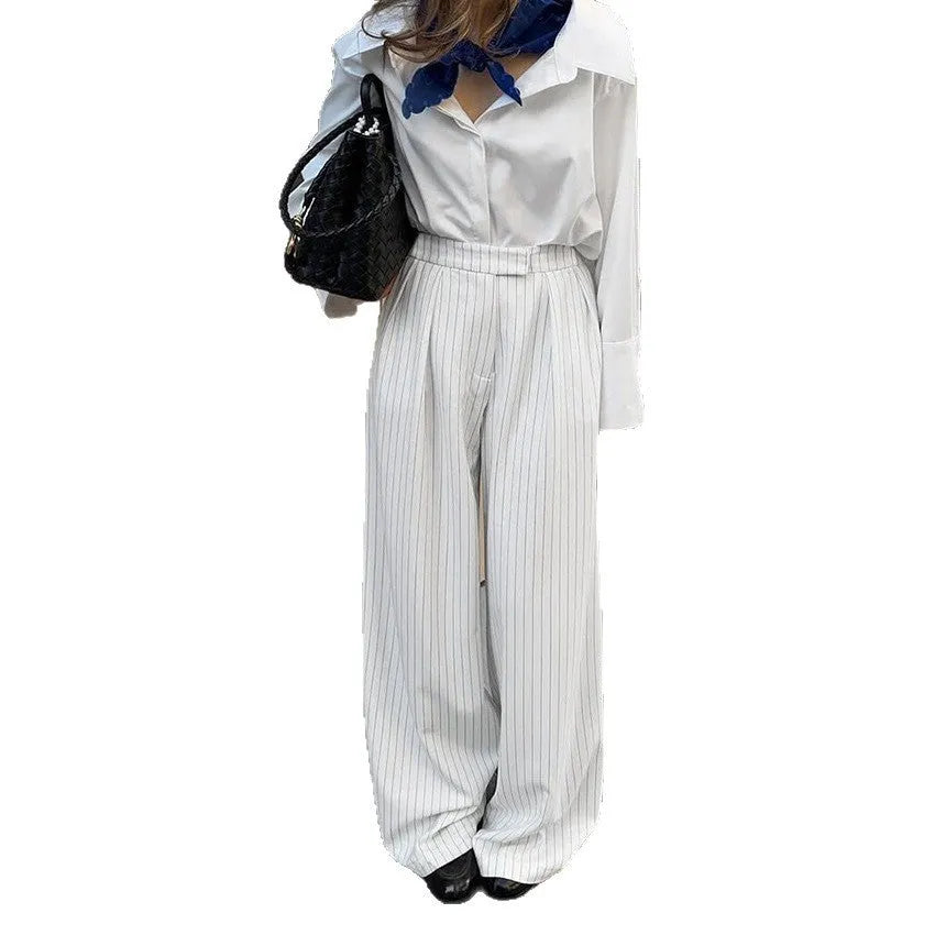 Women's white striped wide-leg trousers with side zip on mannequin