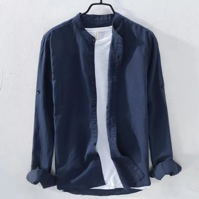Man wearing a loose fit light blue linen blend long sleeve casual button-down shirt.
