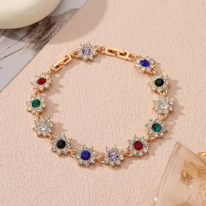 Adjustable zinc alloy bracelet with electroplated flower-shaped links in gold and silver colour options with gemstone accents.
