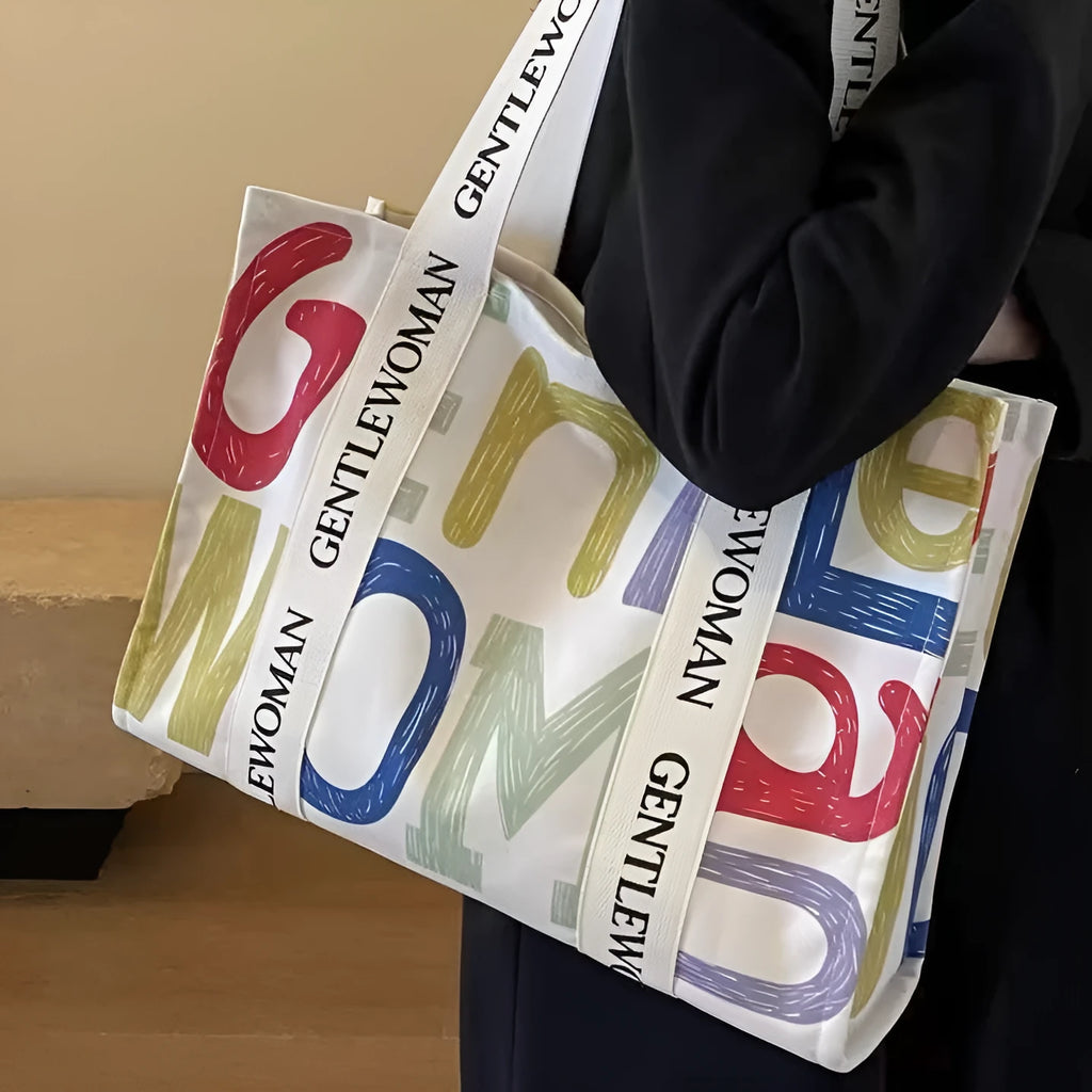 Canvas tote bag with printed design options including black letters, coloured letters, and pattern styles