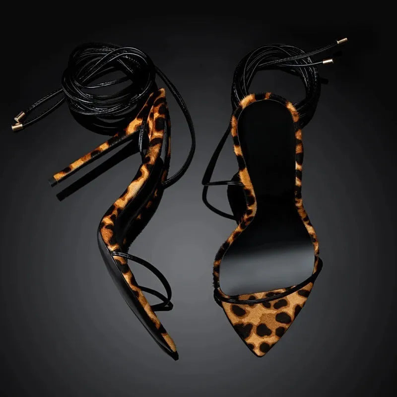 Women's leopard print pointed toe sandals with Roman lace-up straps and buckle fastening.
