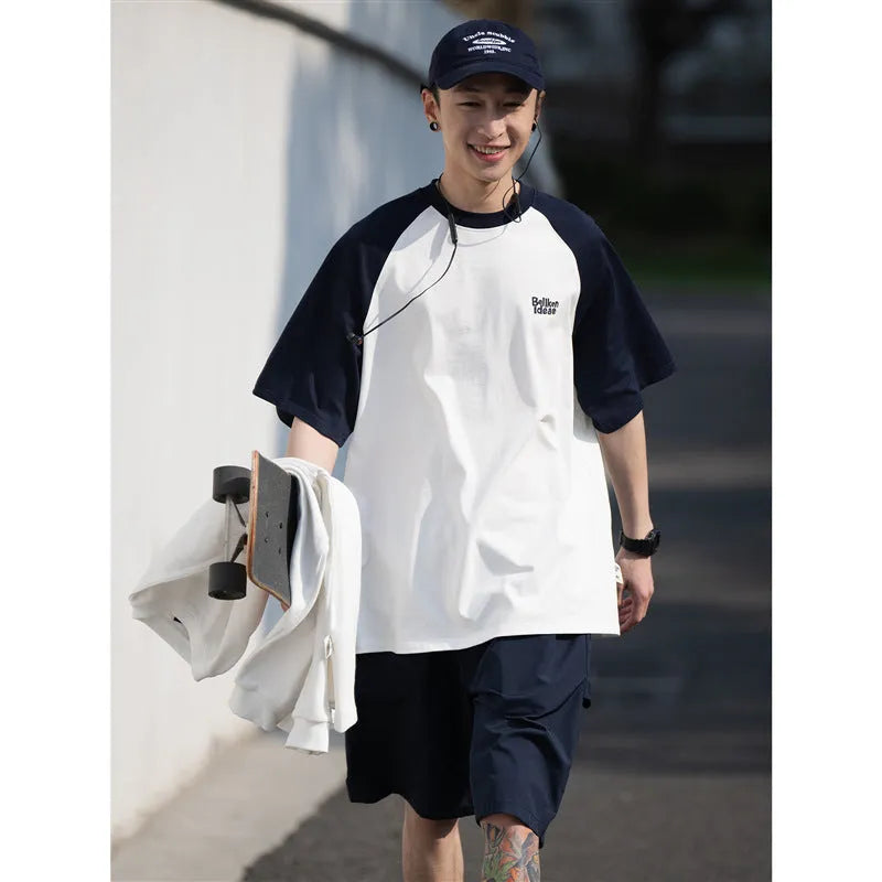 Men's loose blue raglan sleeve T-shirt made from thin polyester blend fabric.
