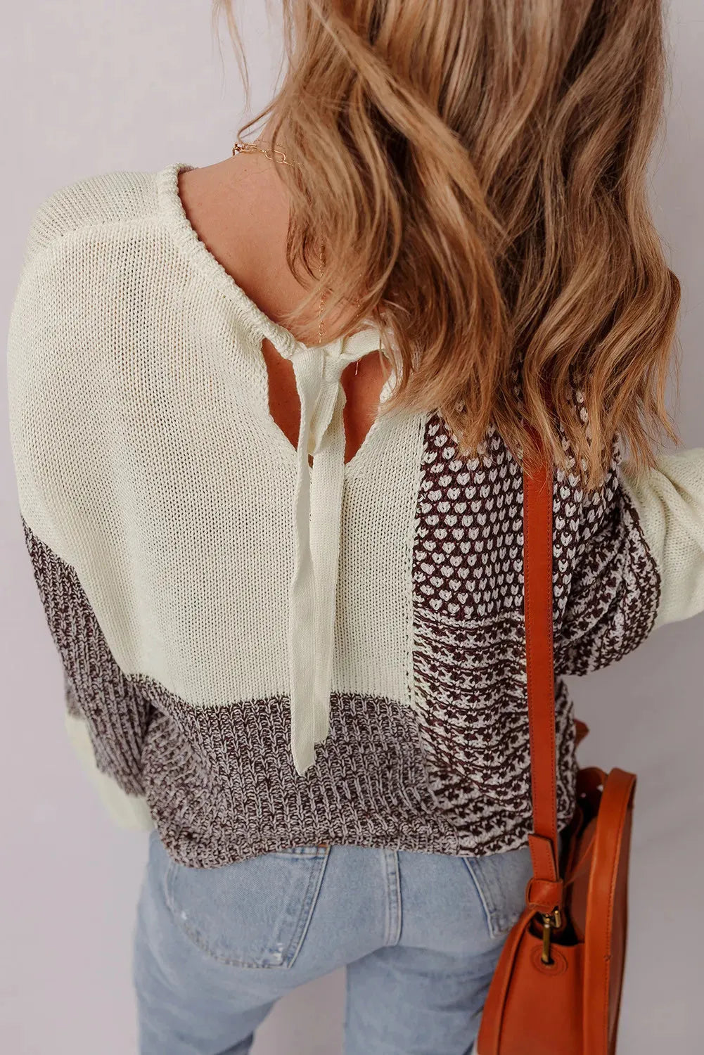 Dark khaki loose sweater with drop shoulders, colour block pattern, and a tie at the back.