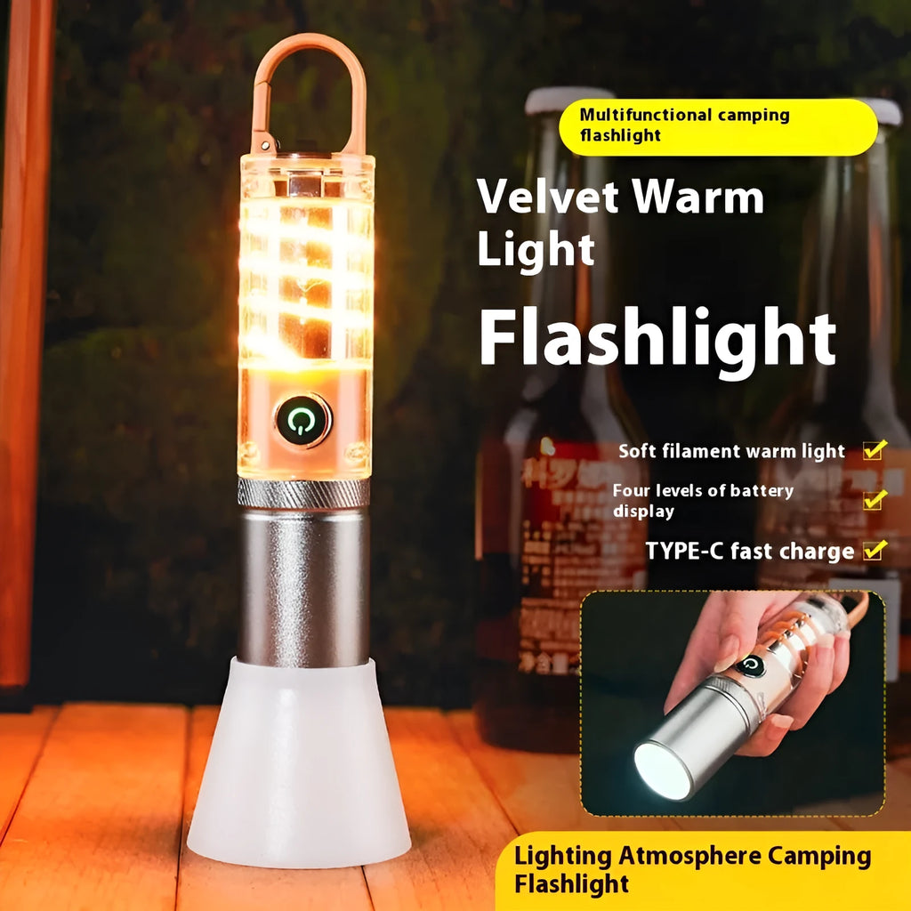 Orange and beige coloured LED torch with keychain loop, showing dual-light lens and USB port.