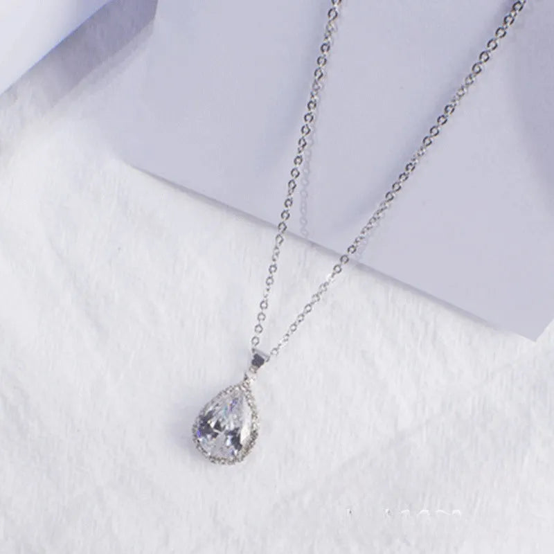 Women's geometric drop shape pendant necklace with rhinestone detail in pink electroplated finish.