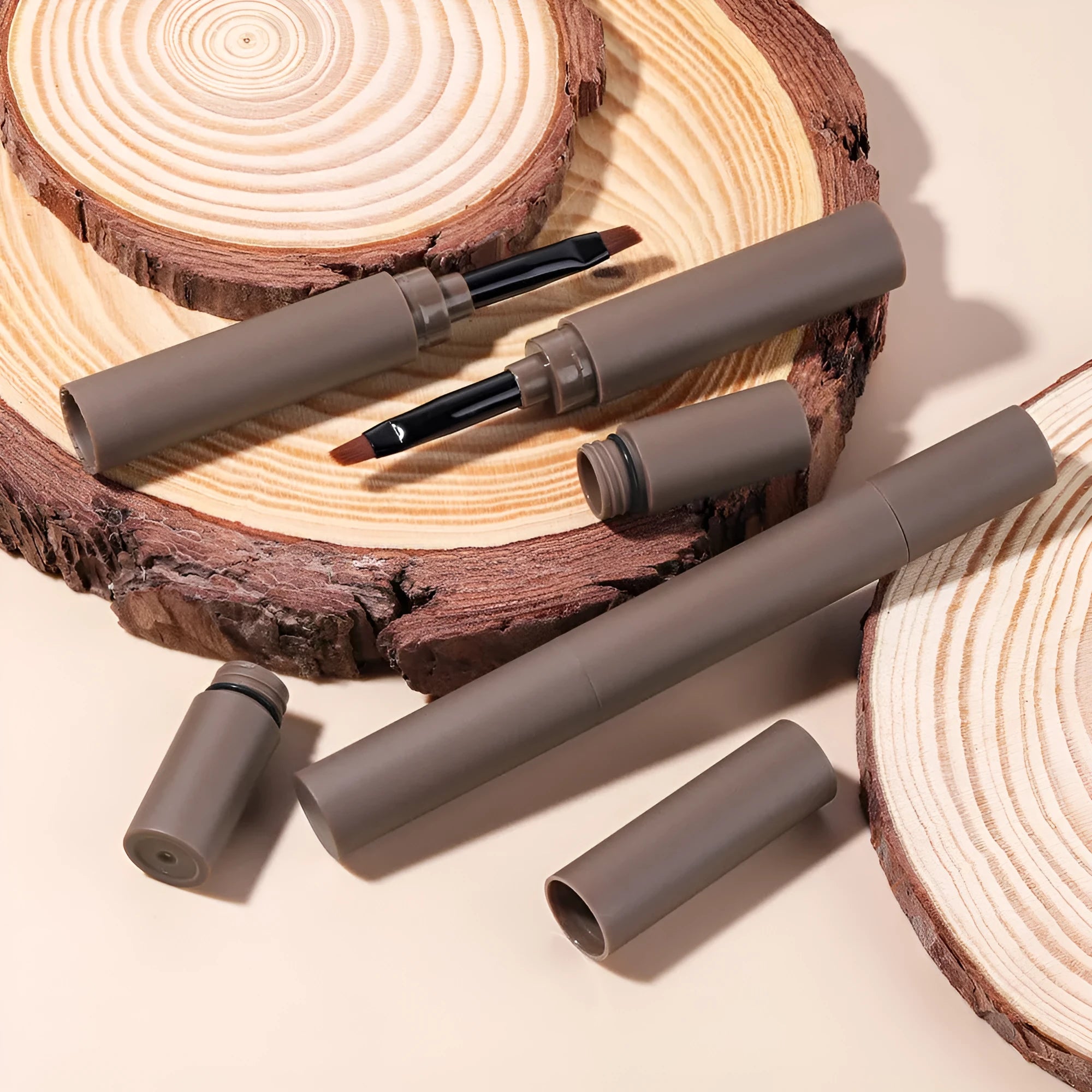 Double-headed eyebrow cream with pencil and powder ends showing five brown shade options