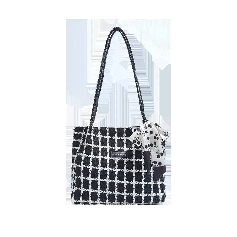 Black woolen shoulder bag with weaving details showing sandwich pocket exterior and interior organisation compartments