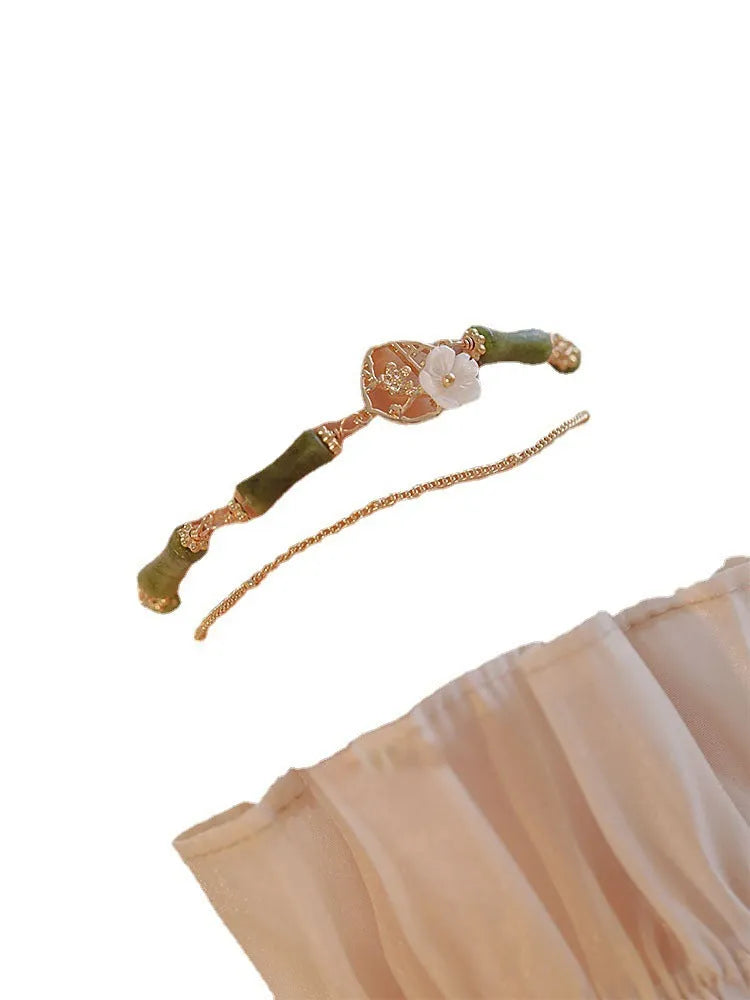 Handmade natural olivine women's bracelet with Chinese double layer twin bells and an olive branch design.