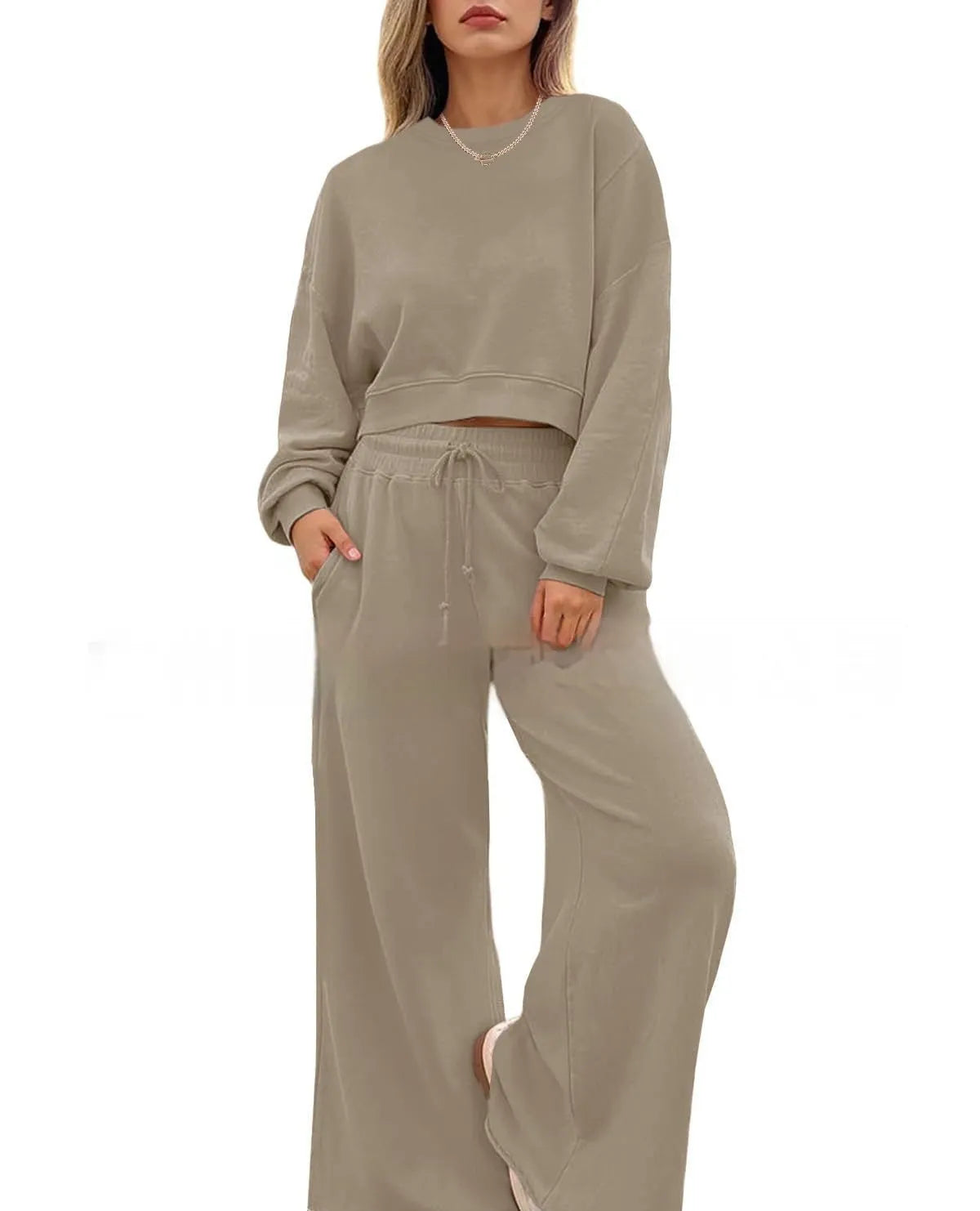 Women's apricot colour polyester trousers two-piece set with long sleeves laid flat.