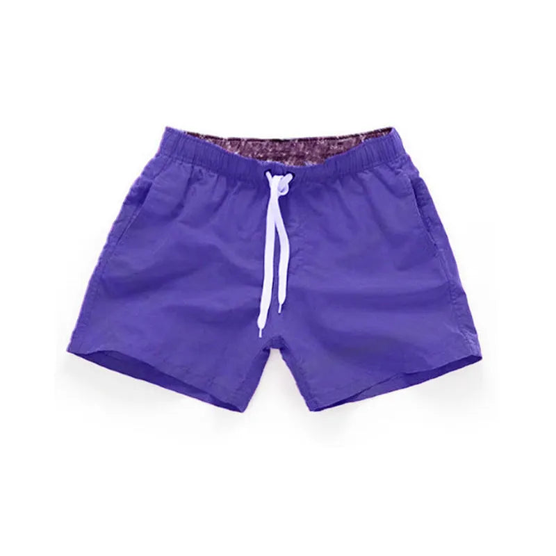 Men's black polyester beach shorts with straight leg opening on a mannequin