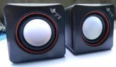 Black square USB-powered 2.0 mini desktop computer speakers on a desk