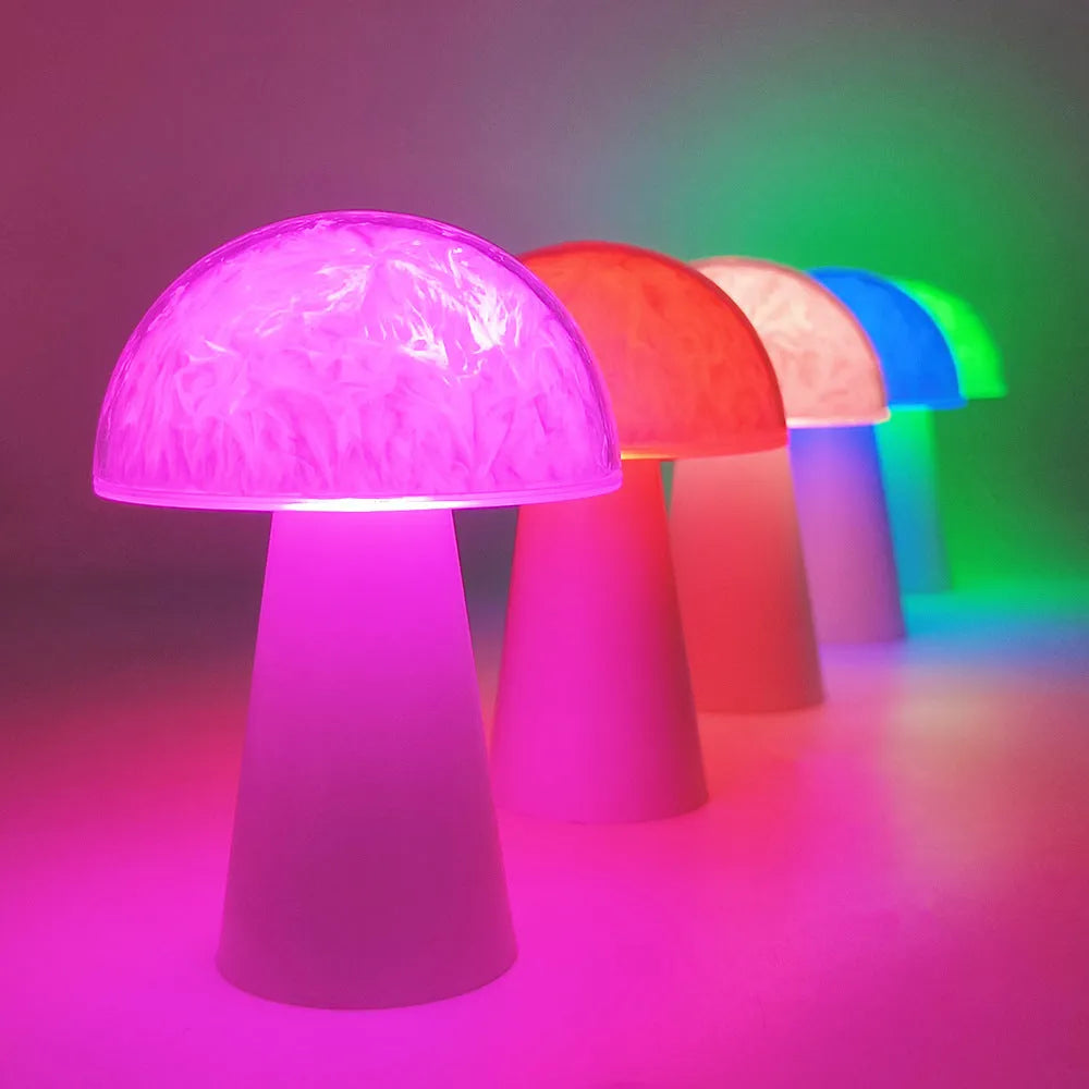 Mushroom-shaped RGB colour changing ambience lamp with remote control on wooden surface