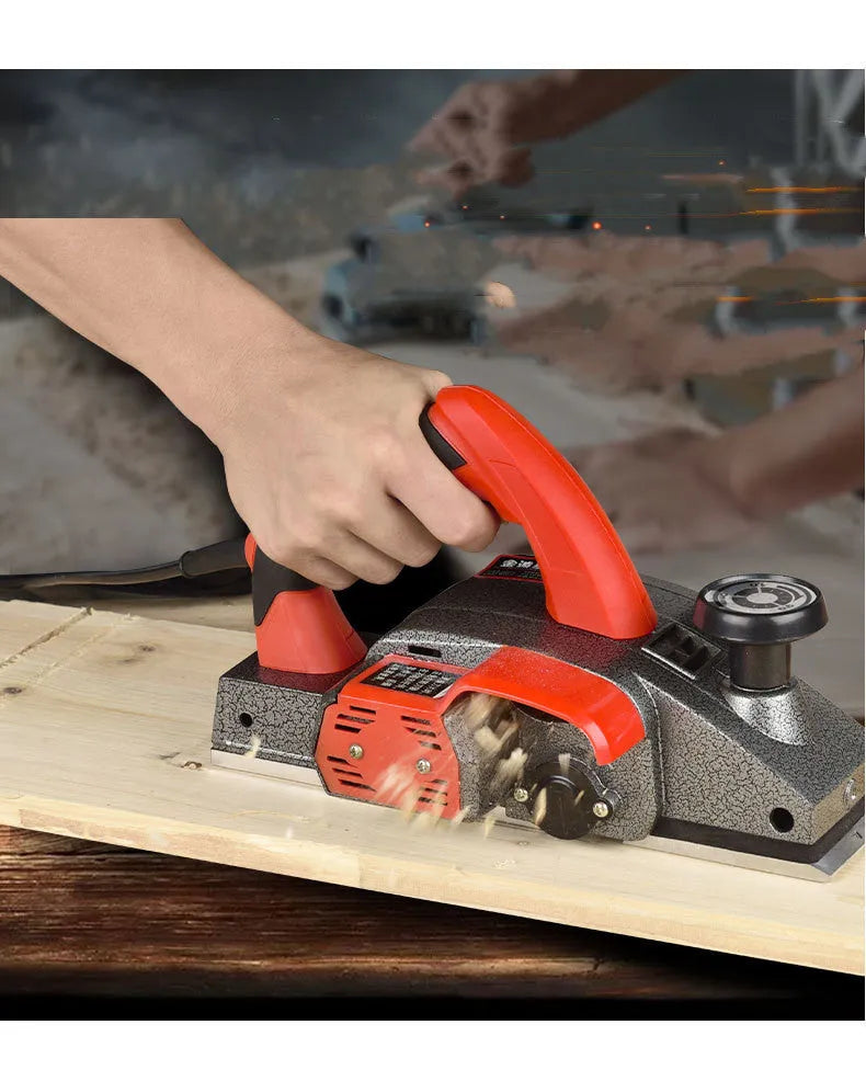 Red electric wood planer with aluminum body for carpentry and workshop use