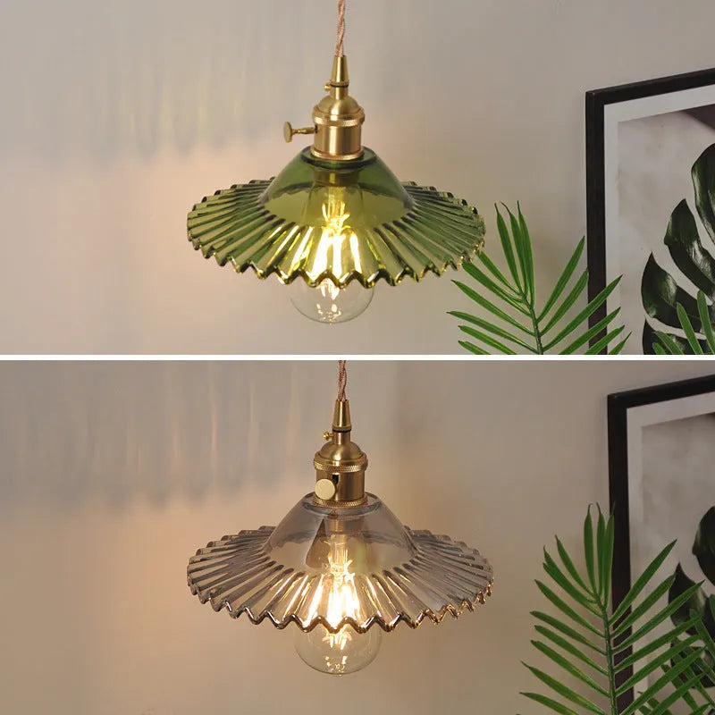 Brass lotus wall lamp with glass shade in six colour options on a wall