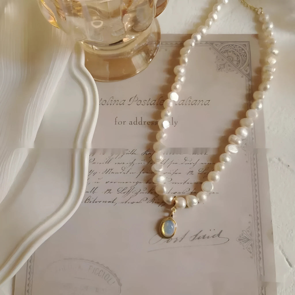 Adjustable French court vintage style pearl necklace with geometric design on a model.