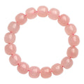 Pink natural crystal barrel bead bracelet with geometric shapes measuring 8-10mm