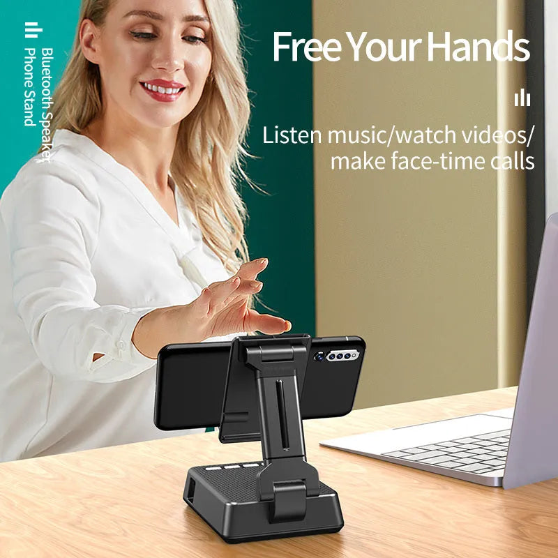 Black mobile phone broadcaster stand with integrated Bluetooth speaker and HD microphone on a desk.