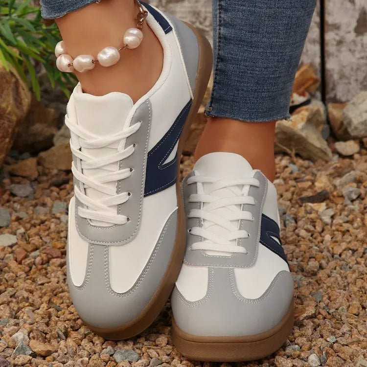 Blue women's low-top hiking training shoes with a lace-up front and rubber sole.