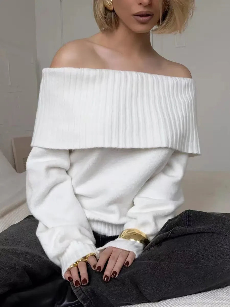 Grey off-the-shoulder sweater with a strapless neckline and a raised 3D pattern across the front.