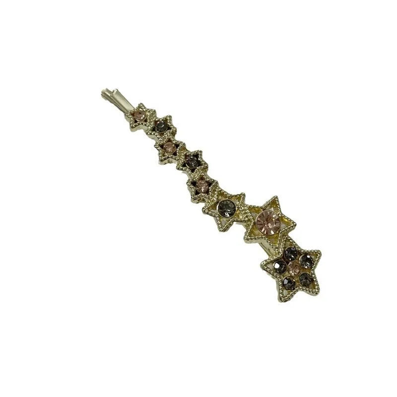 Golden alloy barrette hair clip with rhinestone star decoration and single-word element.