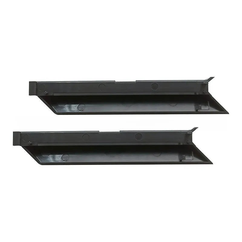 Black PS4 Pro hard drive bottom cover and small plastic repair parts including a baffle and strip.