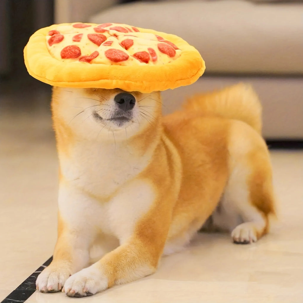 Yellow pizza slice shaped plush squeaky dog chew toy on a white background