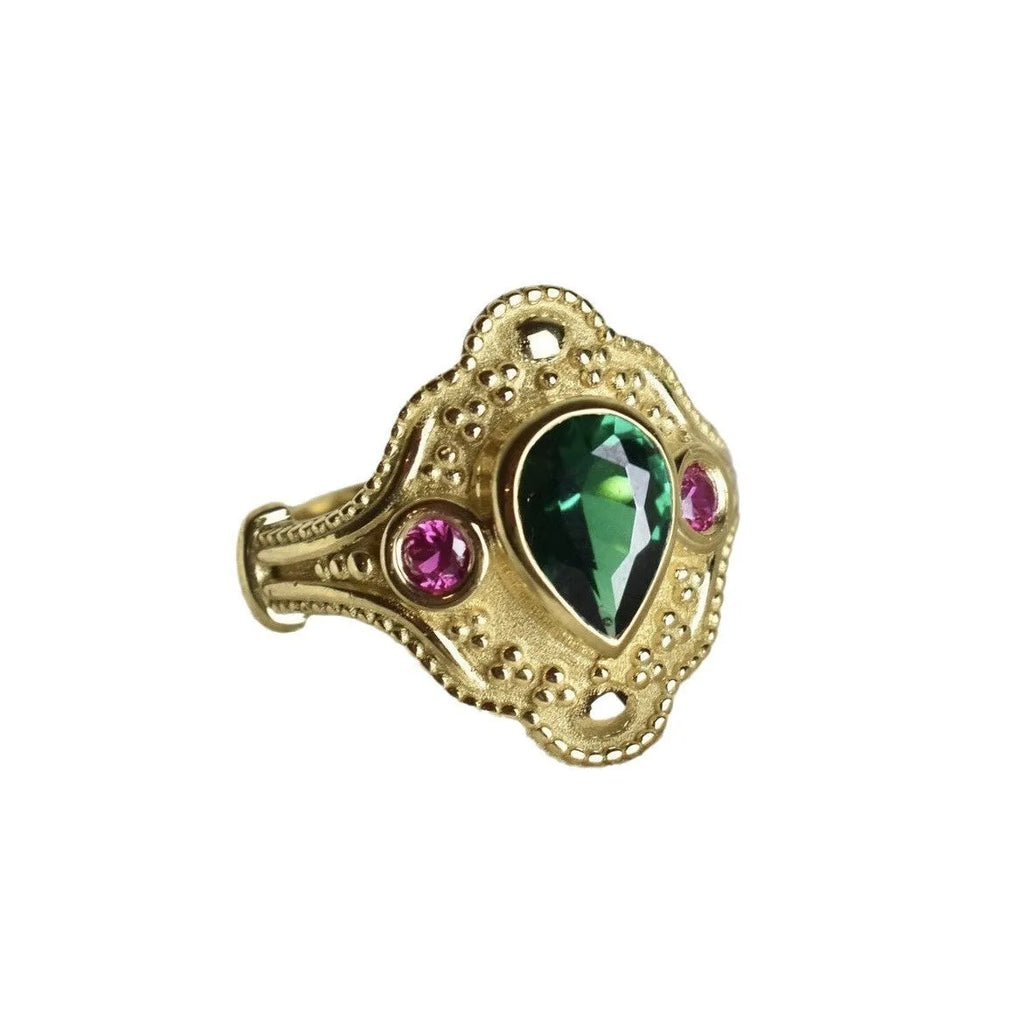 Golden geometric women's ring on a plain background, showing its alloy construction and electroplated finish.