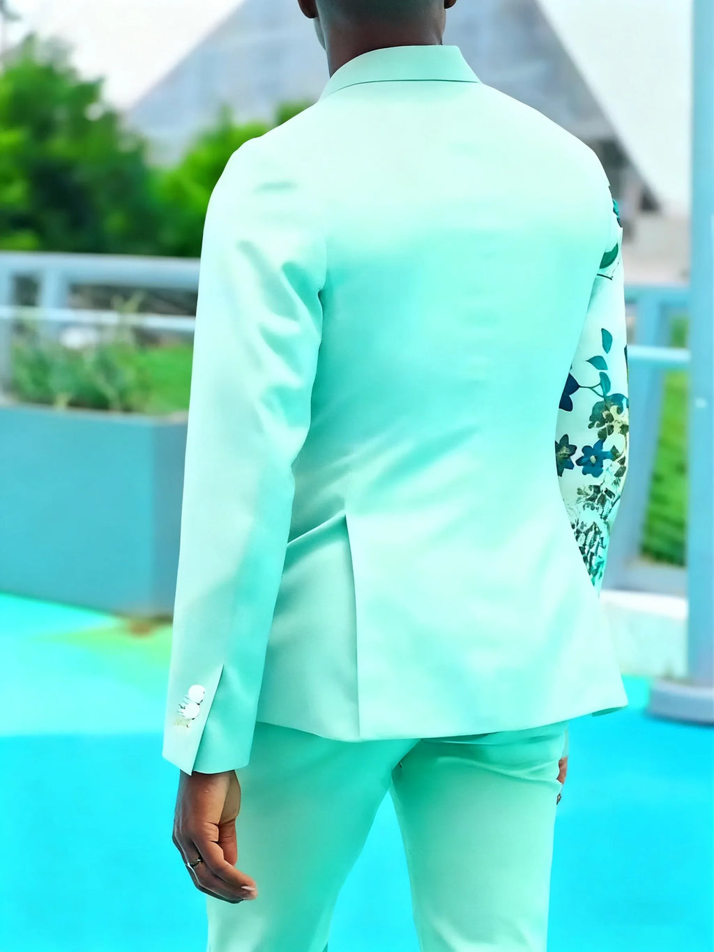 Mint green women's suit with double-breasted blazer and floral print sleeves, paired with ankle-length pants