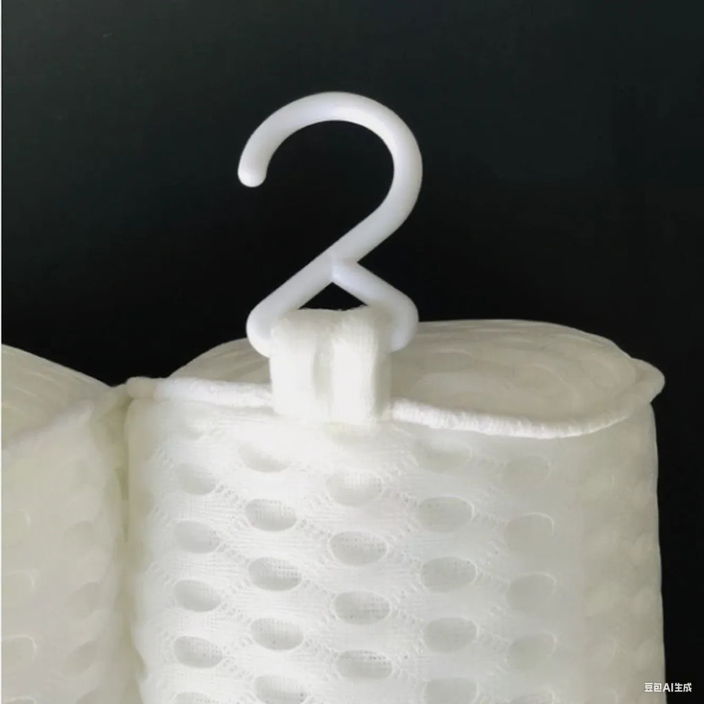 White bathtub pillow with suction cups and mesh construction measuring 37cm by 34cm