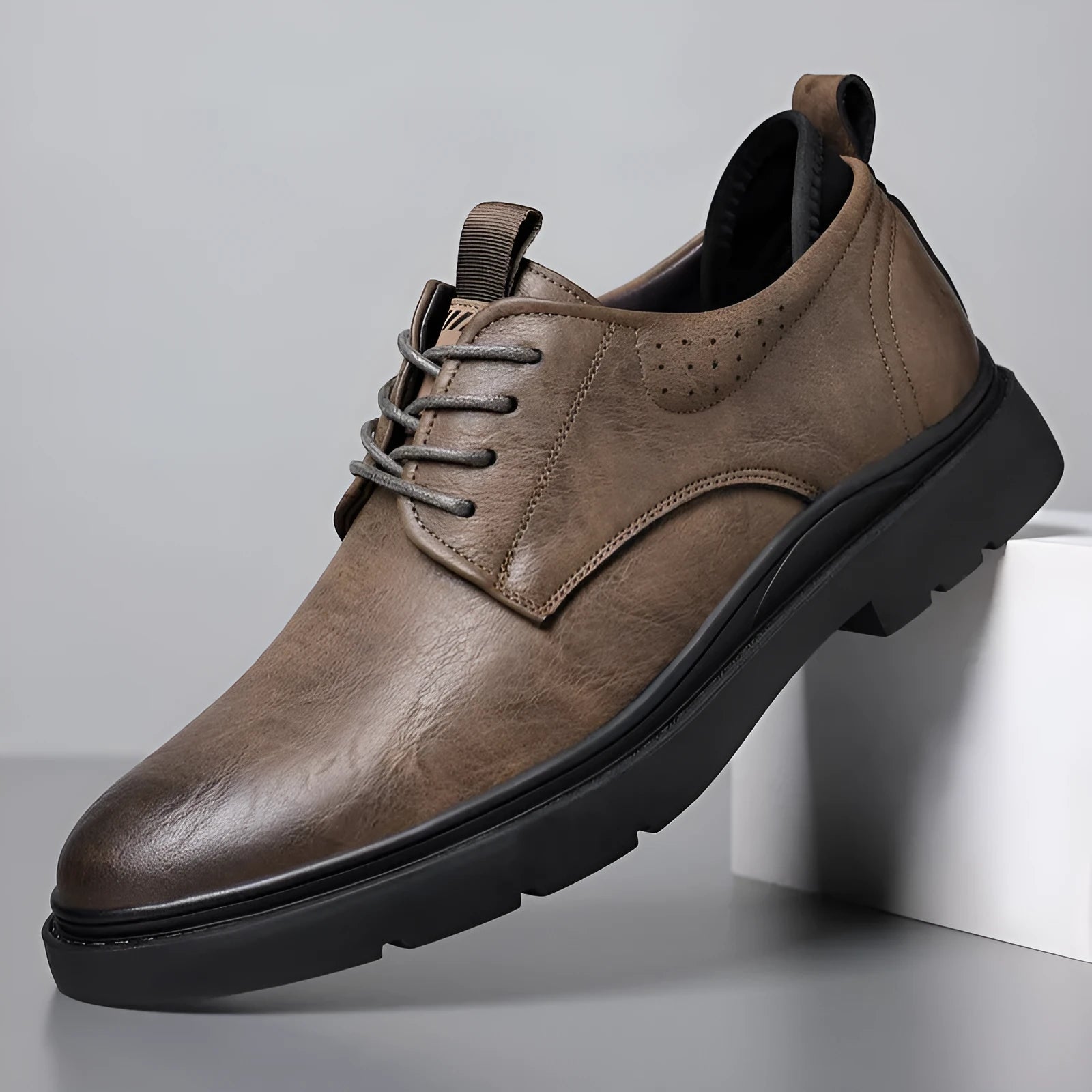 Men's black leather shoes with visible stitching on a two-layer cowhide upper and a rubber sole.