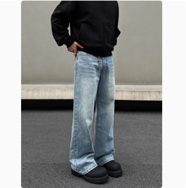 Men's blue straight-leg denim jeans with a whisker wash effect, showing a flared leg and visible stitching detail.